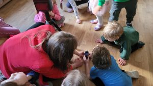 Dzieci dokonują pomiaru za pomocą dalmierza laserowego